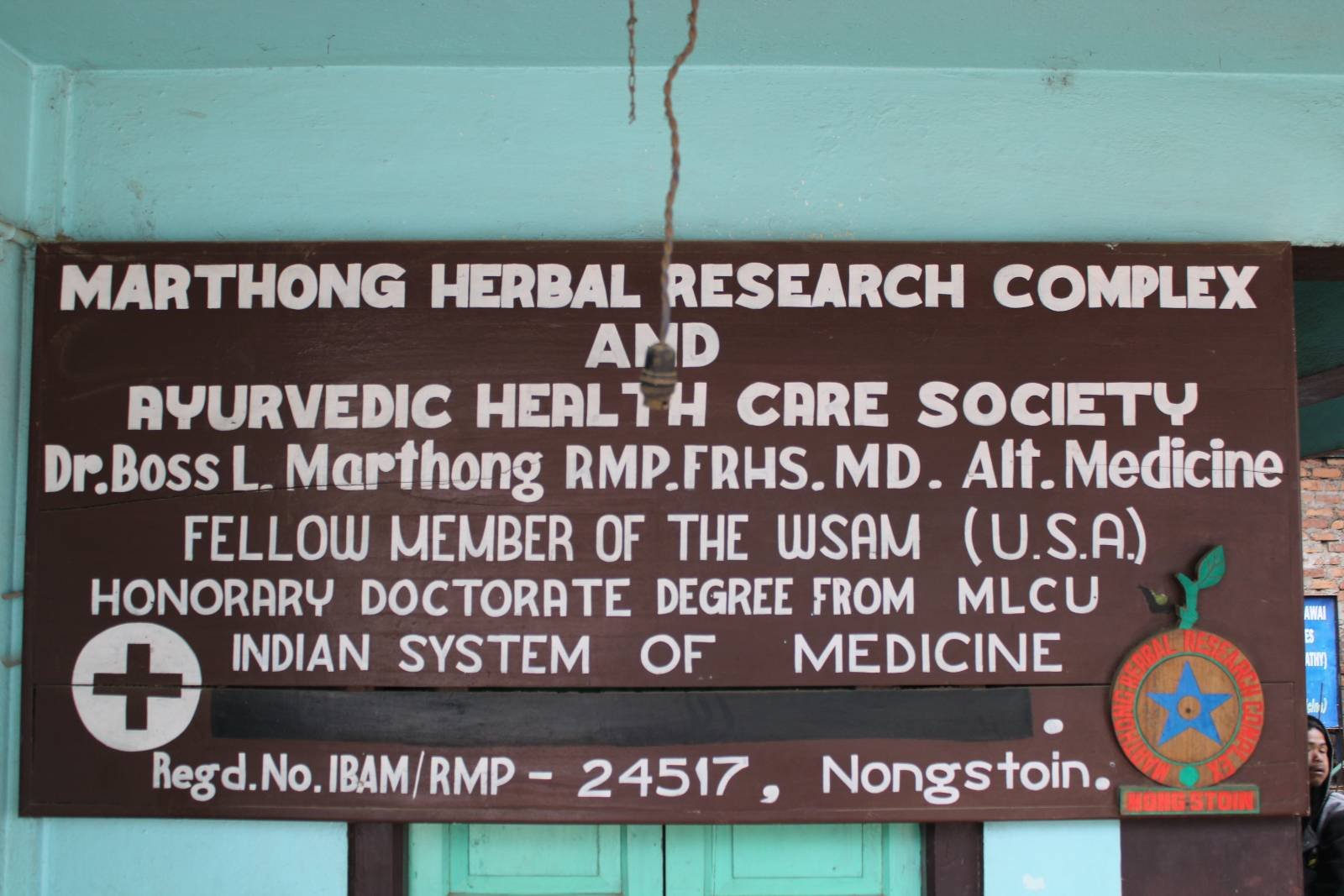 Clinic sign for the Marthong Herbal Research Complex and Ayurvedic Health Care Society