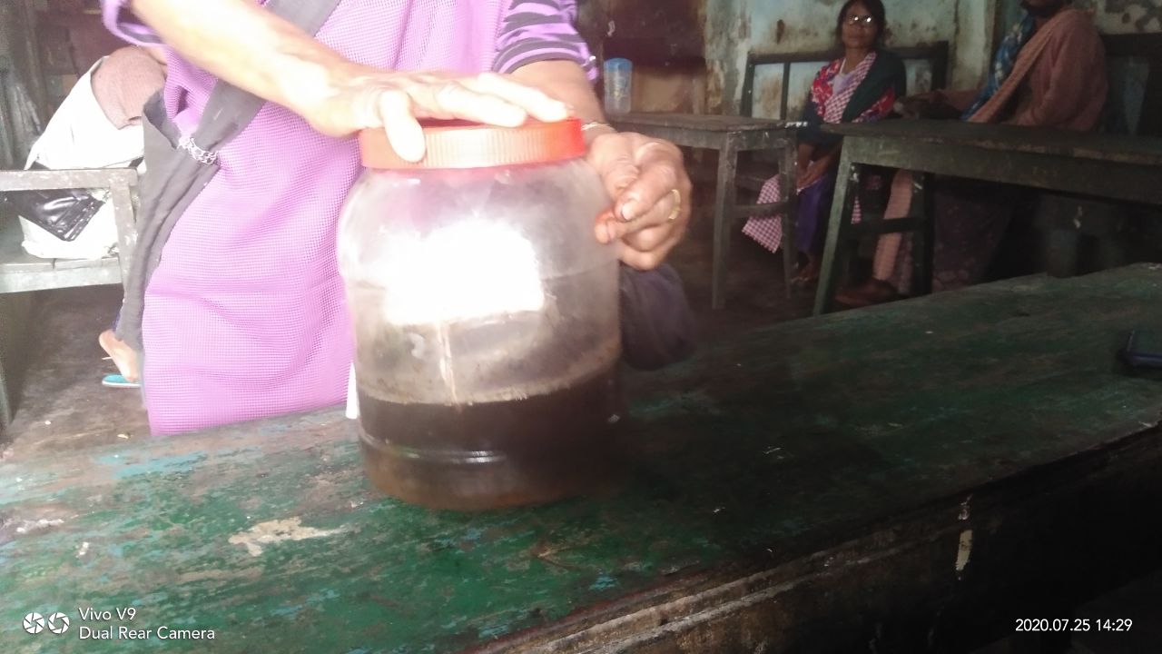 A person working with a jar of liquid medicine